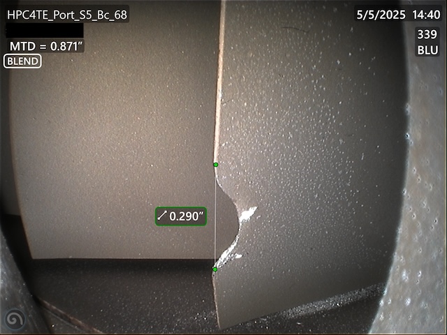 Engineer measuring the length of an HPC blade blend repair